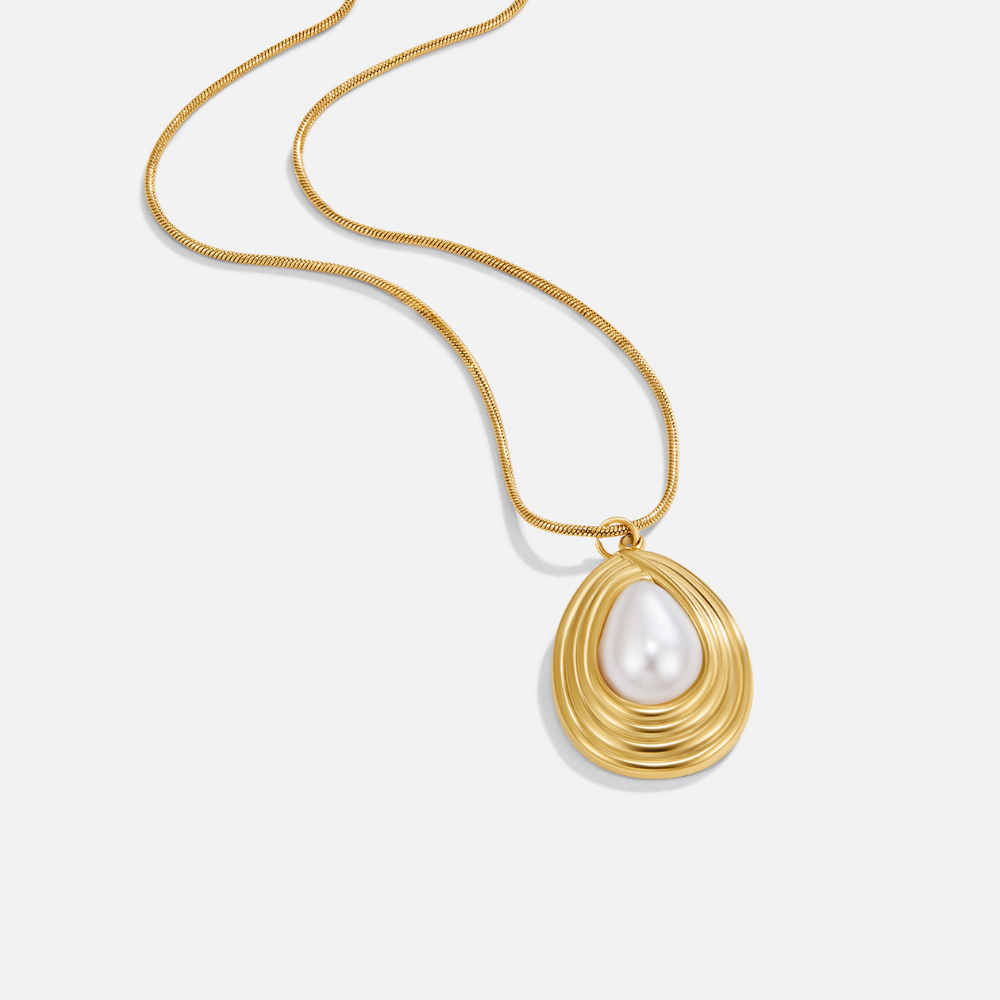 Vintage Camila Teardrop Necklace, flat-lay pendant on white with gold chain and pearl drop