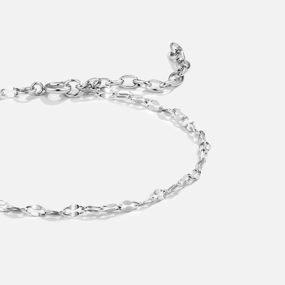 Leila Silver Chain Bracelet, silver chain lying flat on a light background, with an extender tail