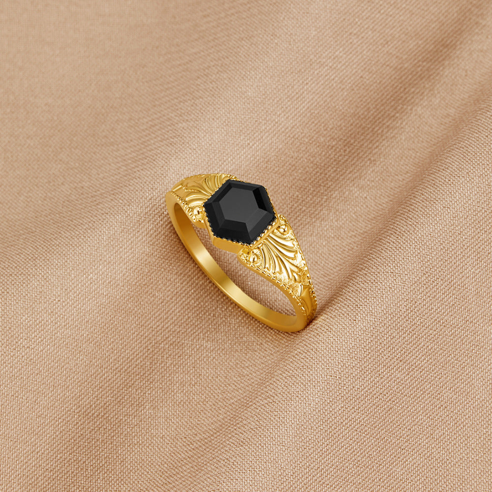Phoenix Black Onyx Ring, gold ring with hexagonal black stone on beige fabric