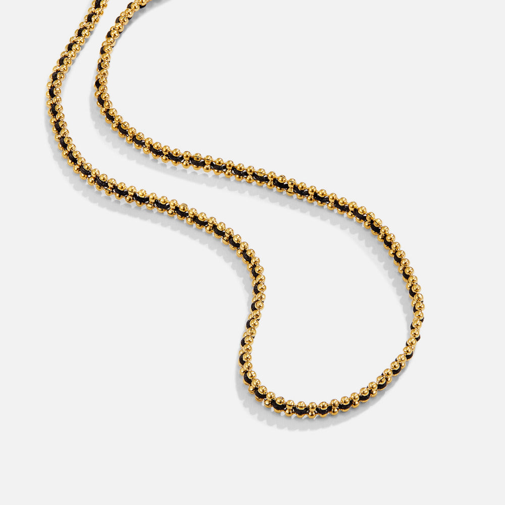 Sofia Bead Chain Necklace, gold beaded necklace with black cord laid on a white surface