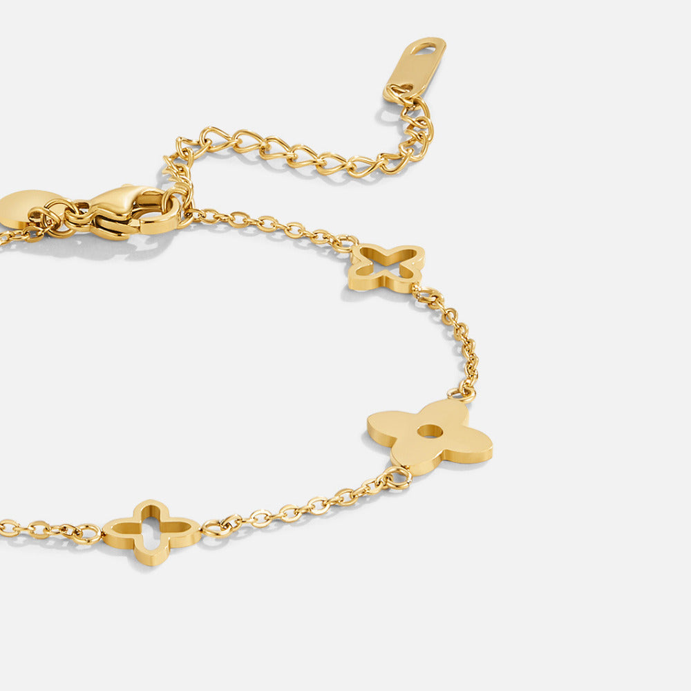 Tori Petal Bracelet, flat close-up of gold chain bracelet with four-petal charms