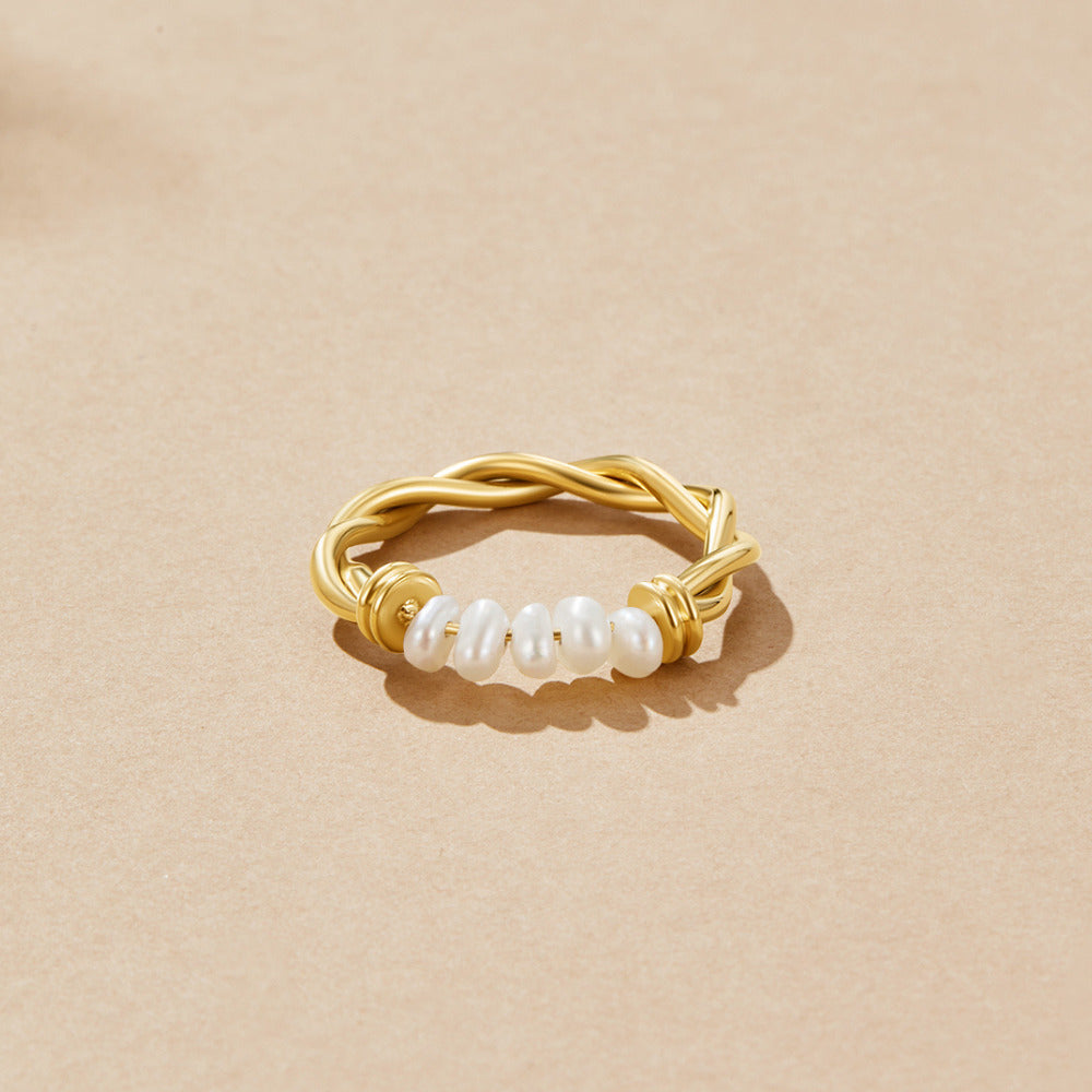 Twisted Classic Freshwater Pearl Ring, ring lying flat on a beige surface, twisted gold band