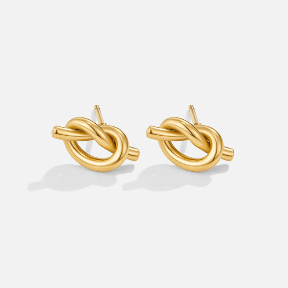 Adela Knot Earrings, pair of polished gold knot stud earrings on a plain white background