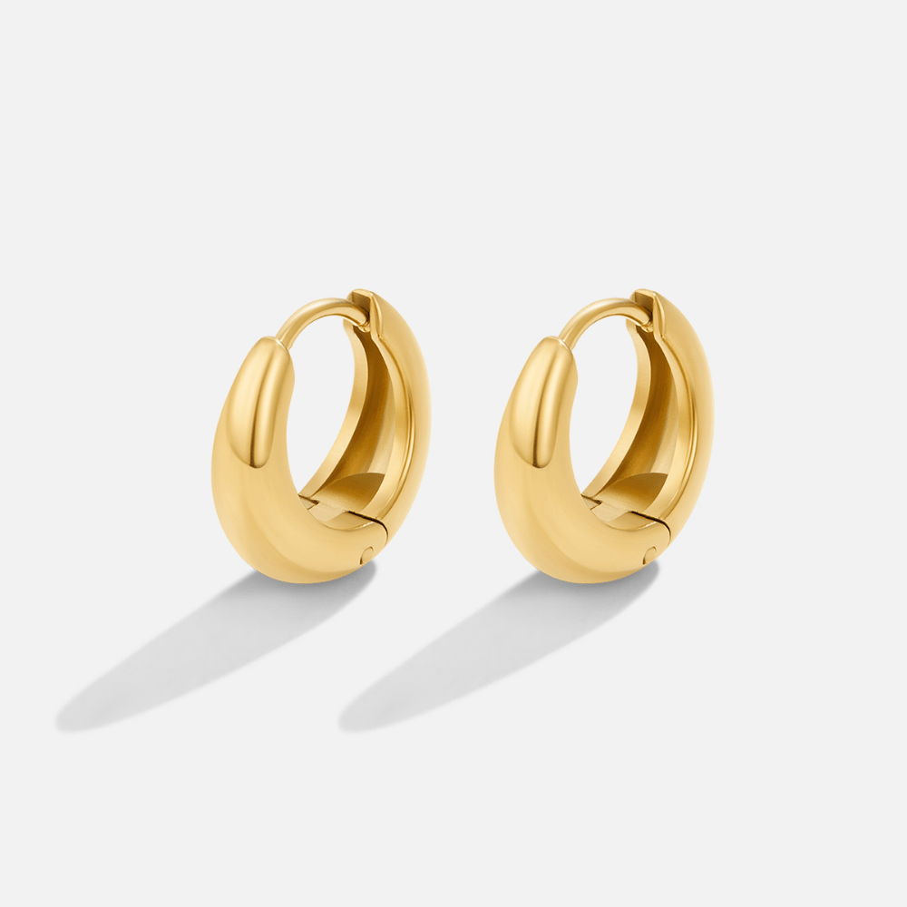 Audrey Gold Hoop Earrings, pair of thick gold hoops on a plain light background