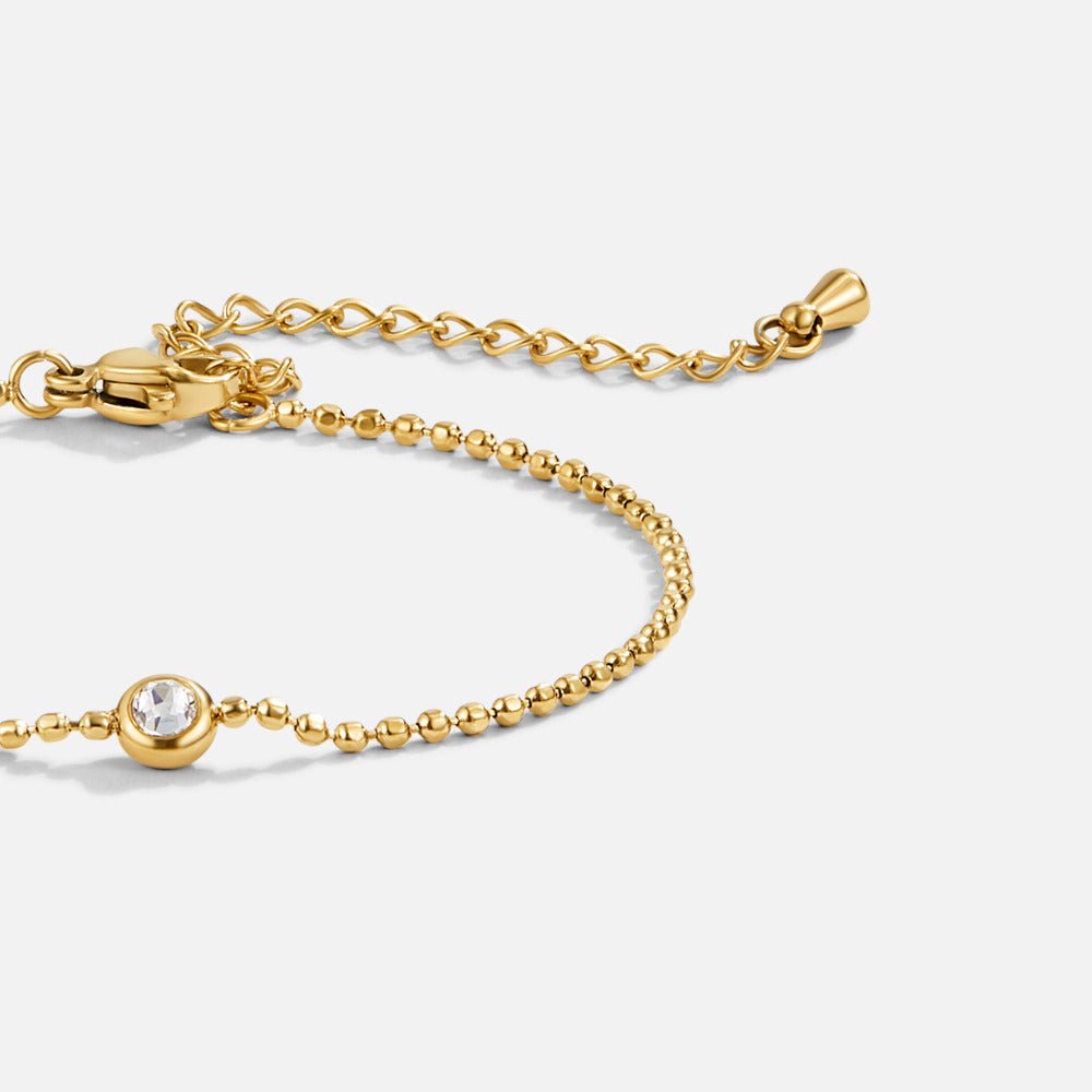 Beaded Gold Aurora Crystal Bracelet, close-up of gold beaded bracelet with clear crystal and
