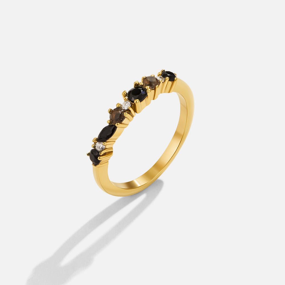 Black Obsidian Eternity Ring, gold band with black and smoky stones, shown alone on white
