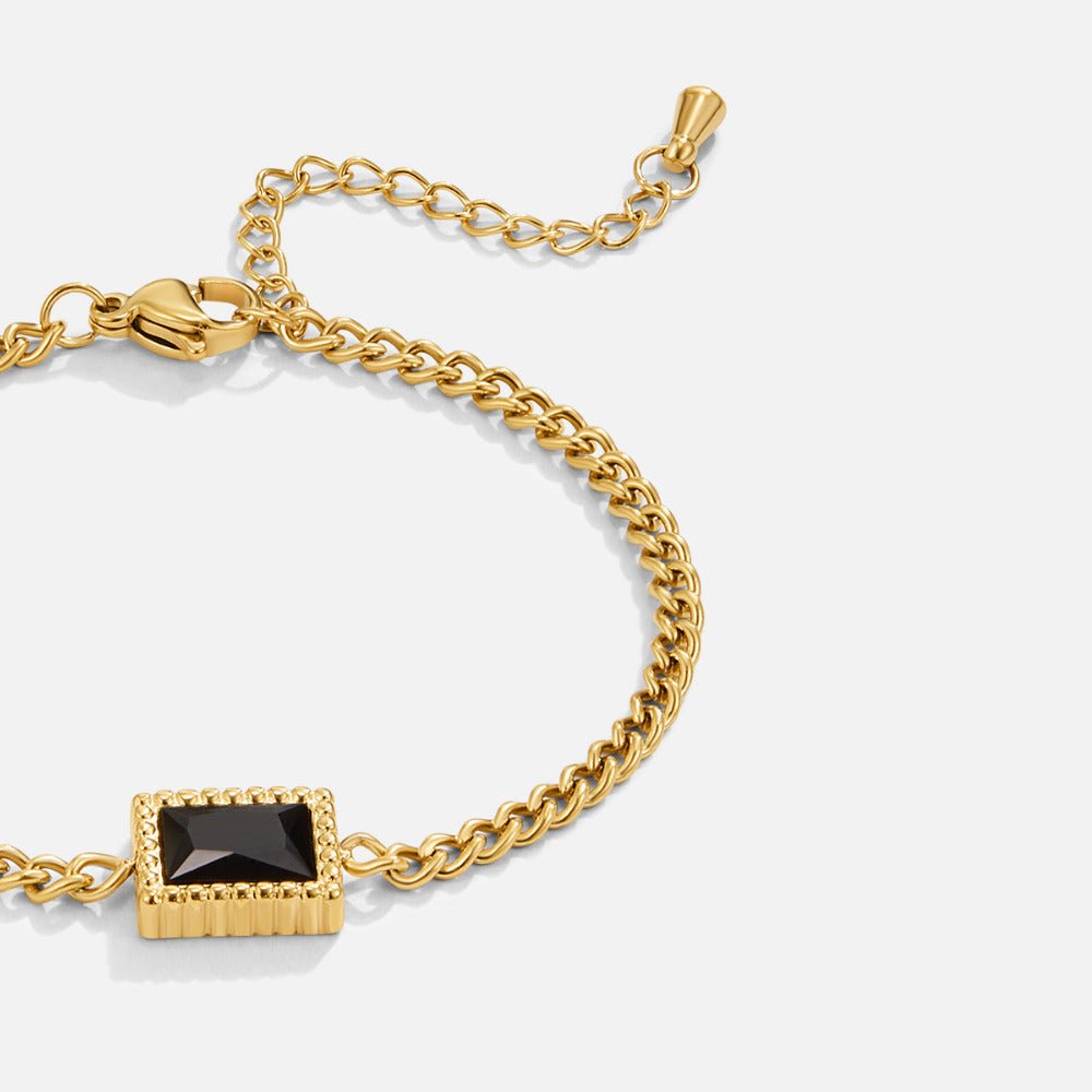 Black Onyx Bracelet, close-up of gold chain bracelet with black rectangular stone, on white