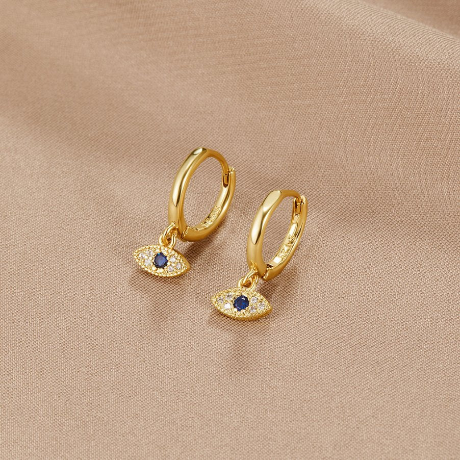 Blue Evil Eye Drop Earrings, pair of gold hoop earrings on beige fabric, evil eye charms with