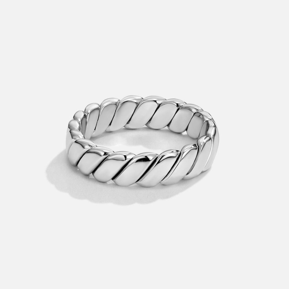 Calira Twisted Infinity Silver Ring, standing upright on a plain white surface, polished