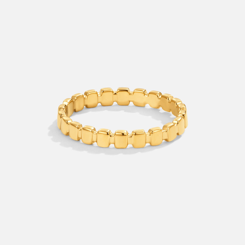 Callie Gold Band Ring, standing upright on white, gold band of rounded blocks