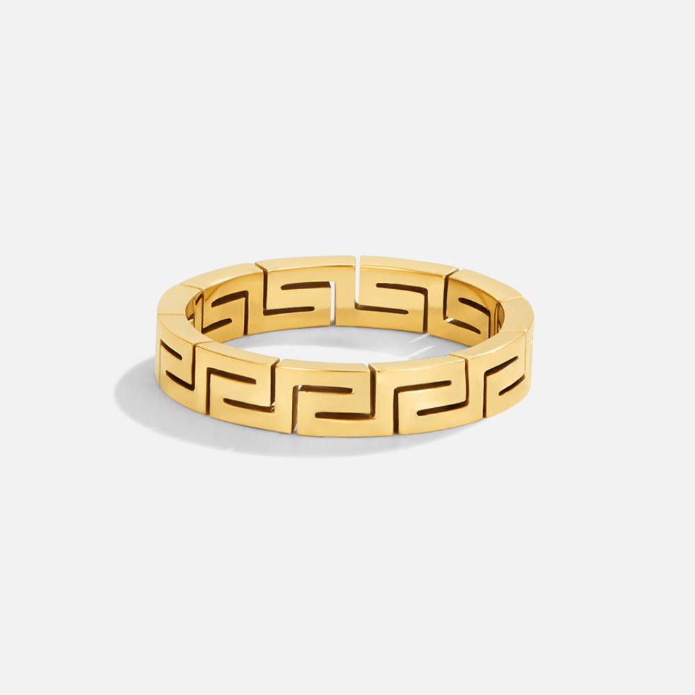Celestine Gold Hollow Ring, gold band with a repeating key-pattern cutout, on white background