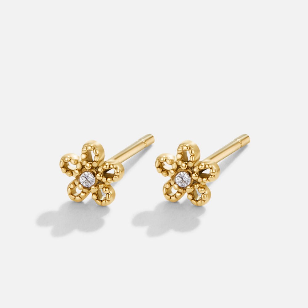 Crystal Daisy Stud Earrings, pair of gold flower studs with a small white stone centre, on white background