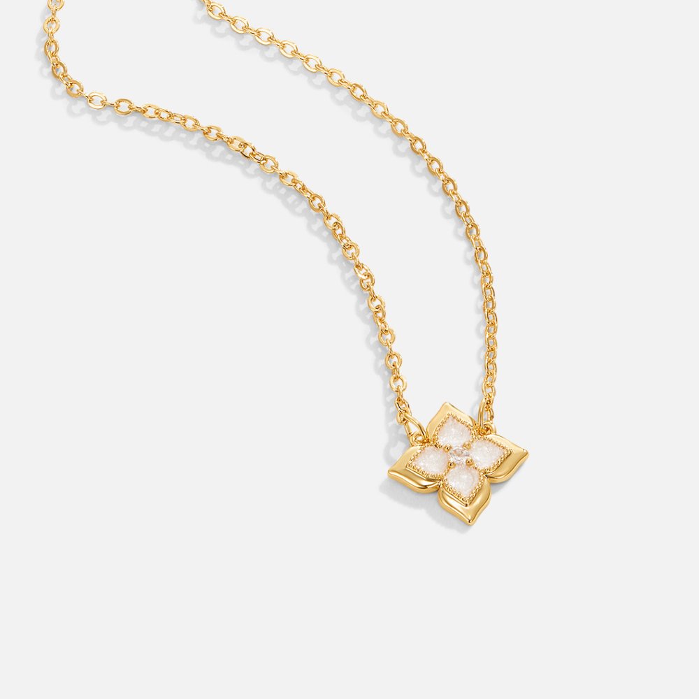 Dalia White Iris Clover Necklace, gold chain necklace laid flat with clover pendant, white