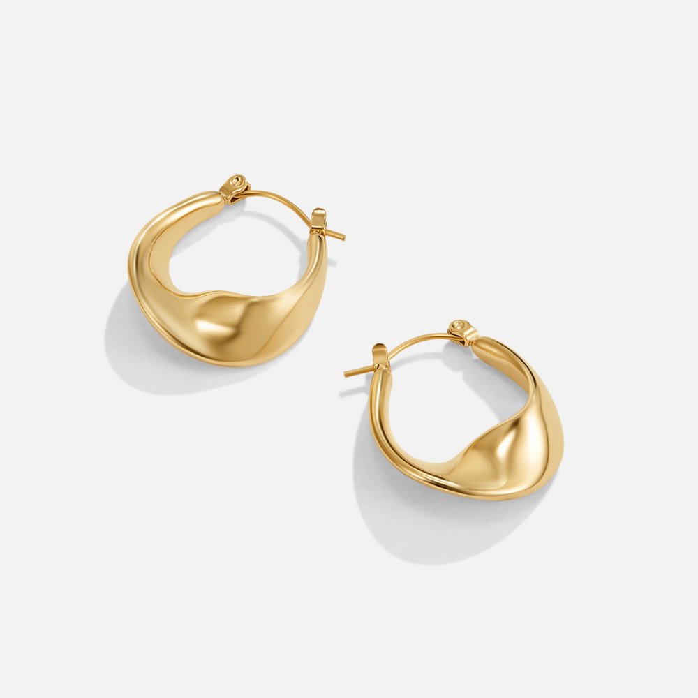 Dara Hoop Earrings, pair of sculpted gold hoops on a white background