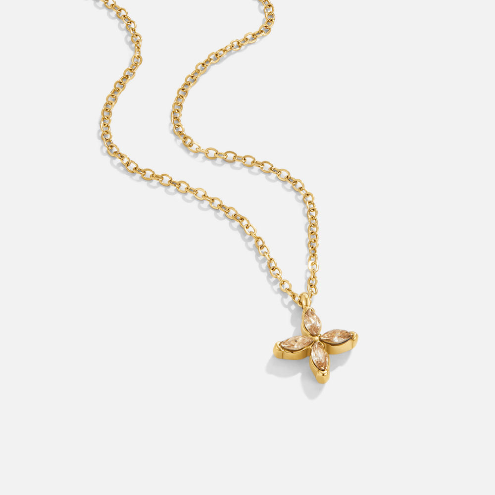 Elowyn Crystal Petal Necklace, laid flat on white, gold chain with a four-petal pendant set
