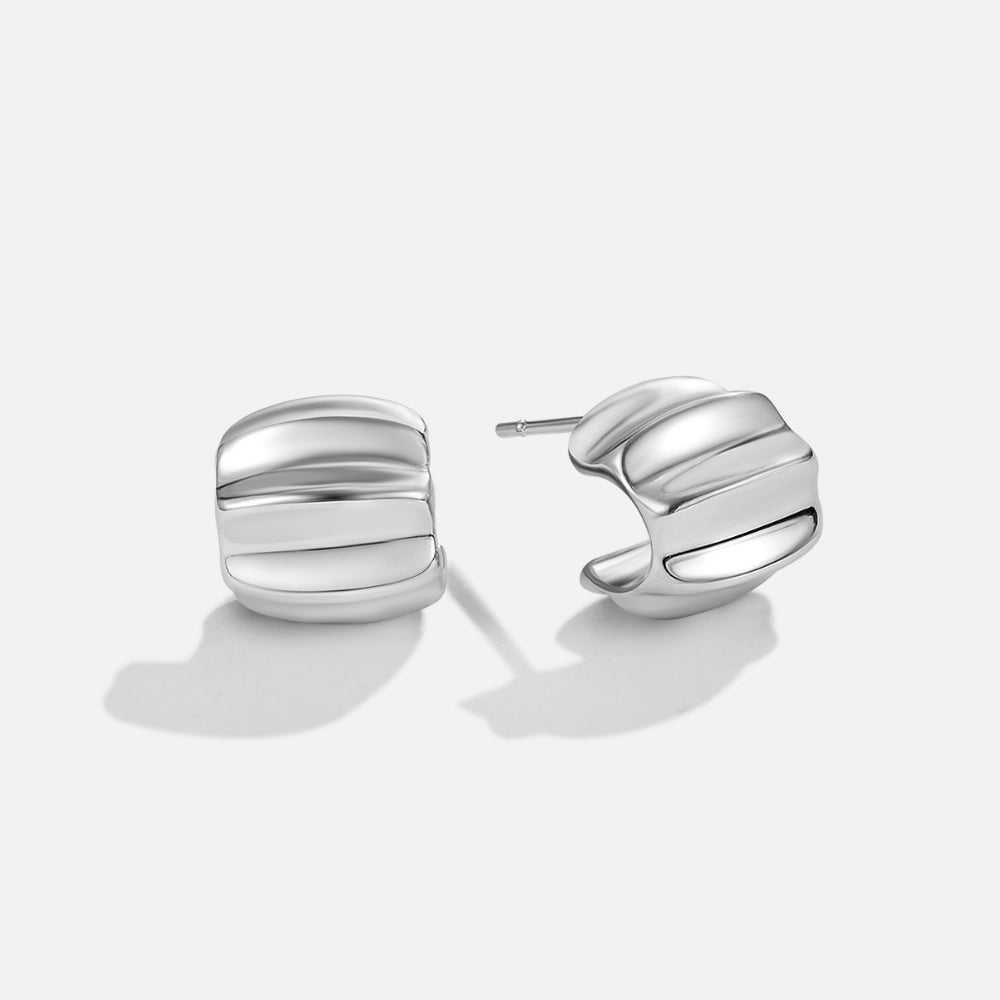 Elsa Mini Wave Silver Hoop Earrings, pair of polished silver earrings on a plain white background