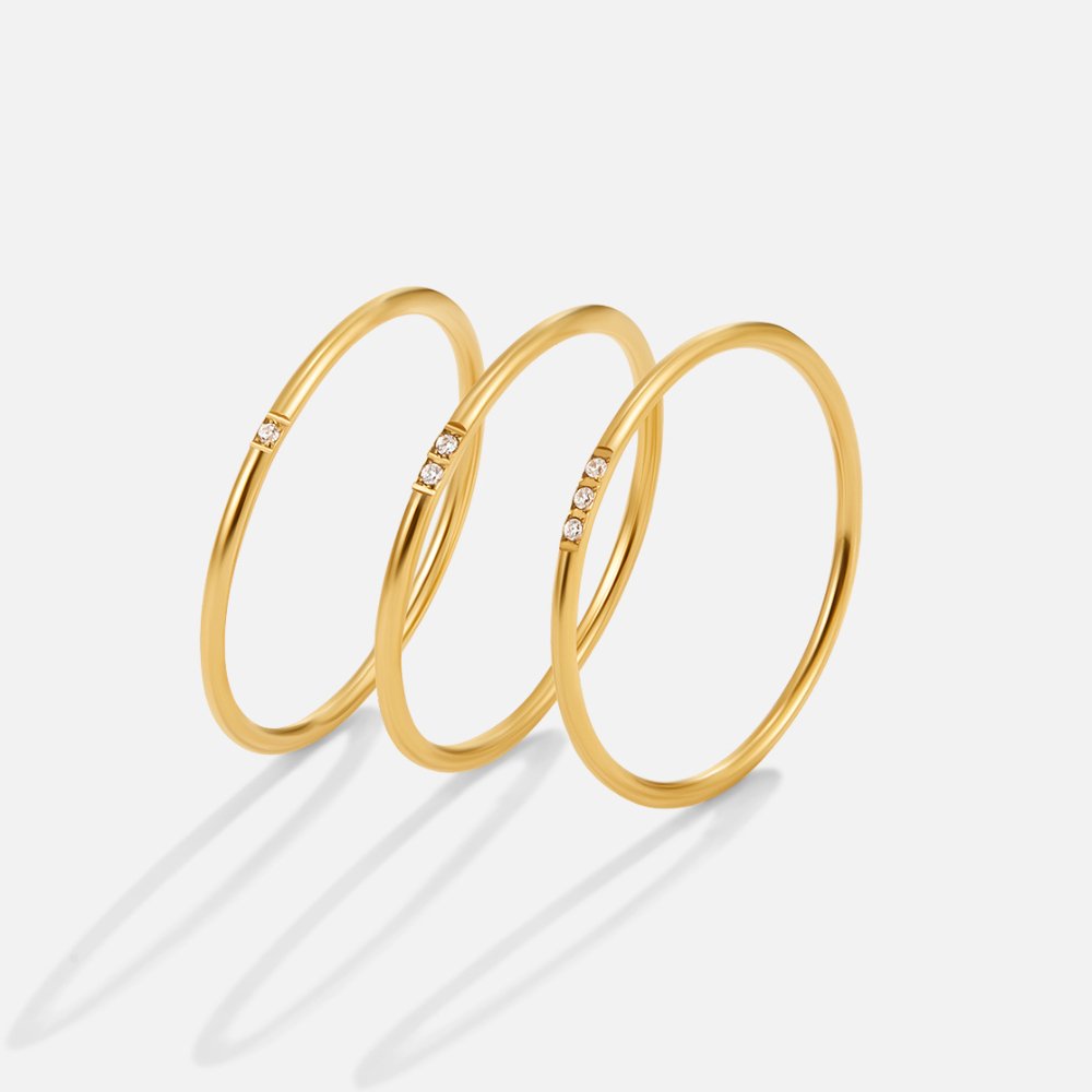 Eula Gold & Crystal Band Ring, three thin gold rings standing upright on white, small stones