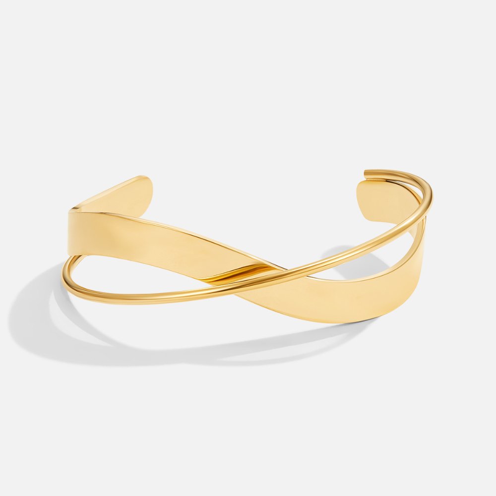 Eve Gold Bangle, open cuff with a crossed wide band and thin wire, shiny gold on white