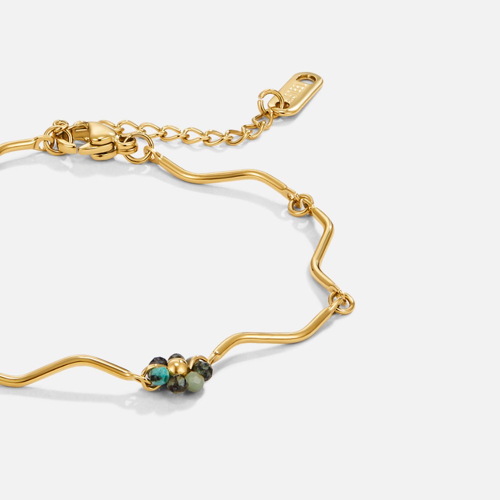 Forest Flower Stone Gold Bracelet, gold wavy bracelet links with a cluster of green beads, on