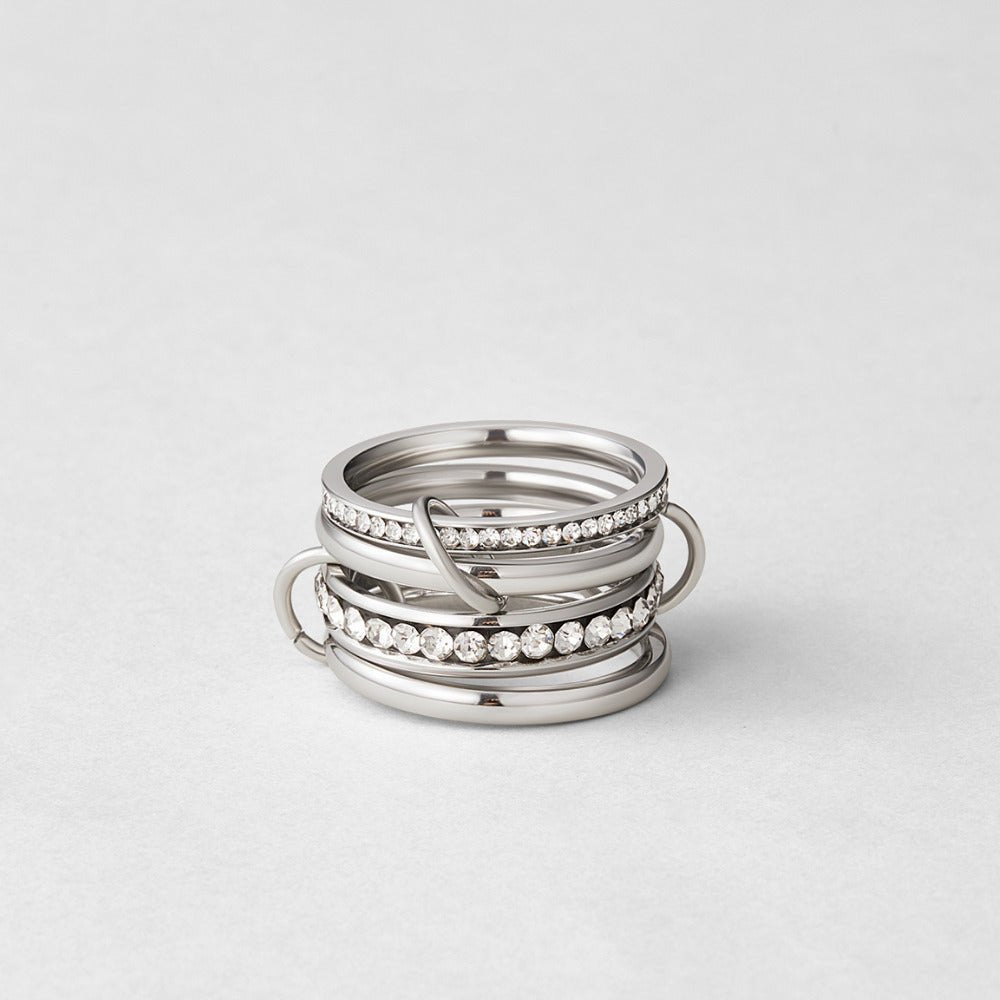 'Forever' Link Crystal & Silver Ring, stacked silver rings with crystal bands on a grey surface