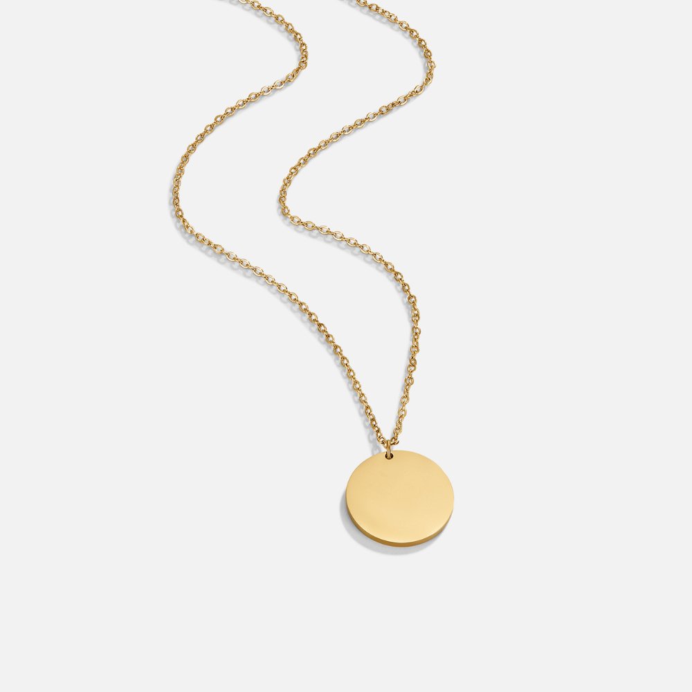 Gold Coin Necklace, gold chain necklace laid out with a round flat disc pendant