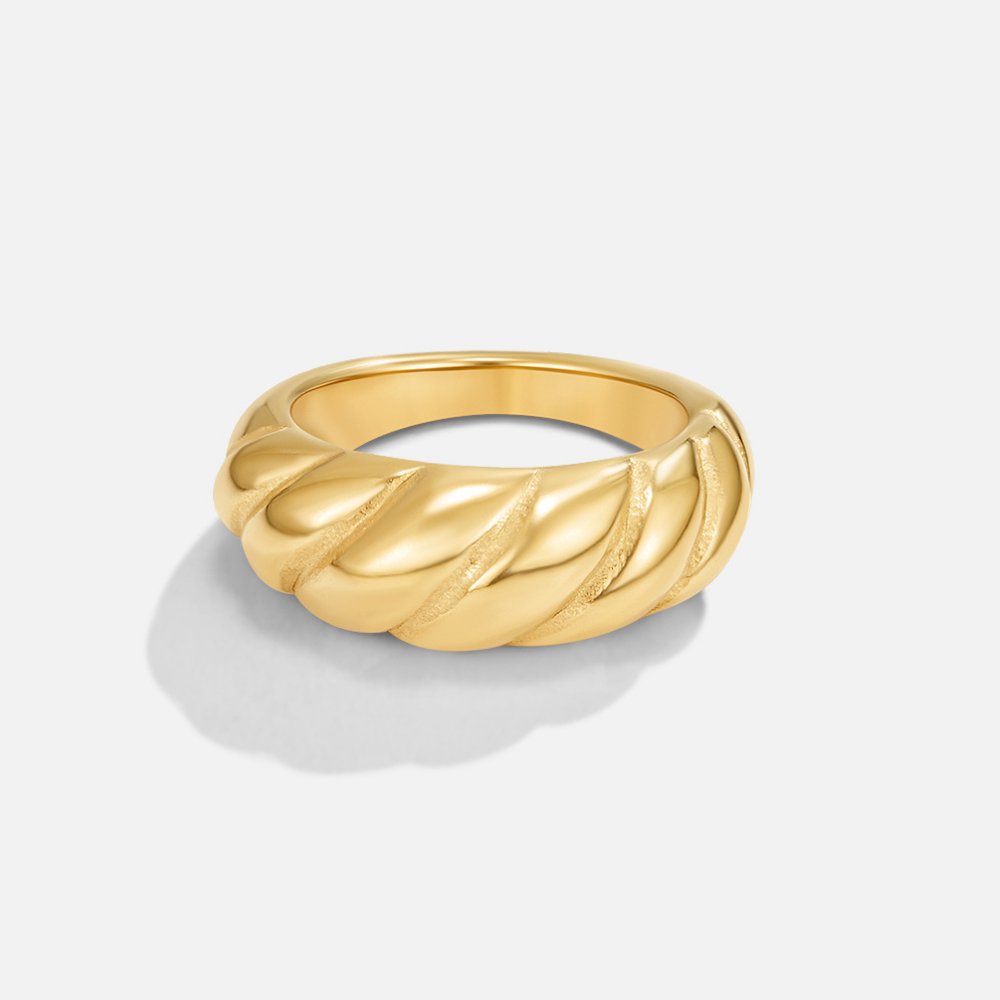 Gold Croissant Ring, single ring on a plain light background, twisted gold ridges