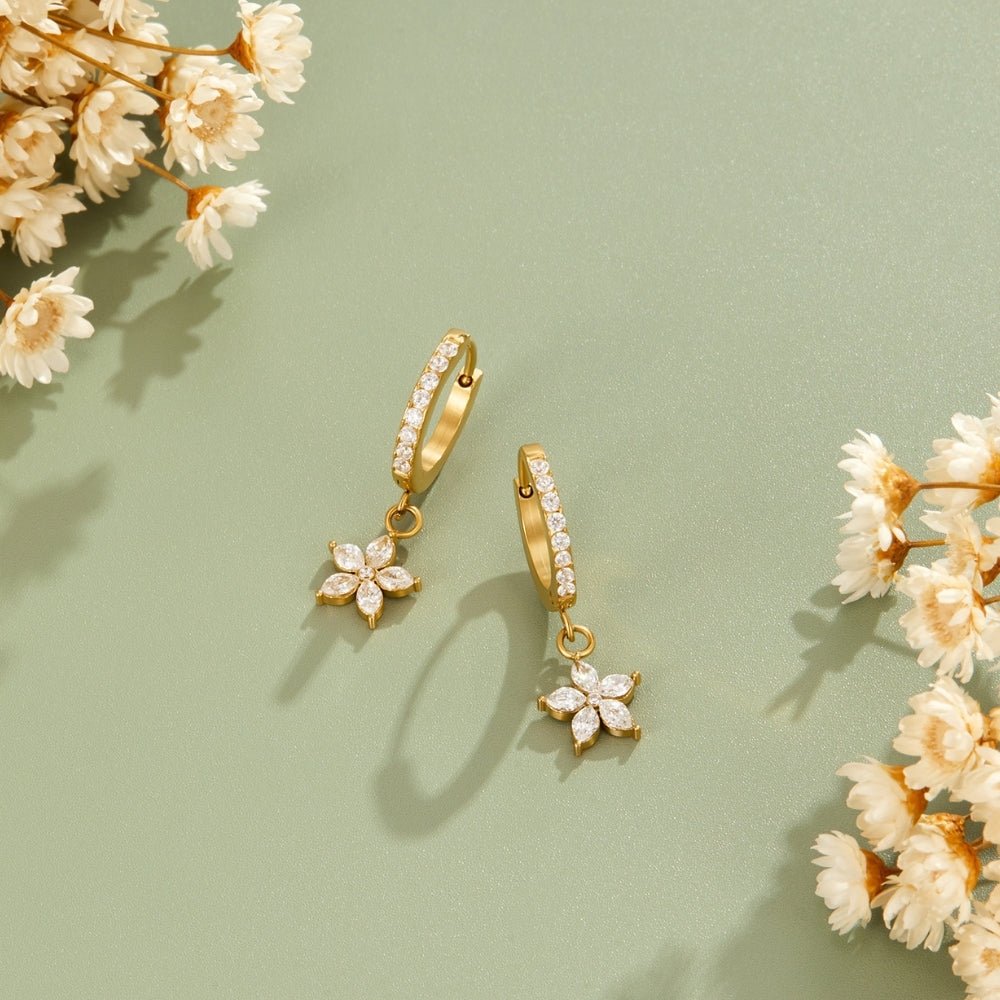 Gold Crystal Petal Drop Earrings, pair of gold hoop earrings with flower drops on sage green