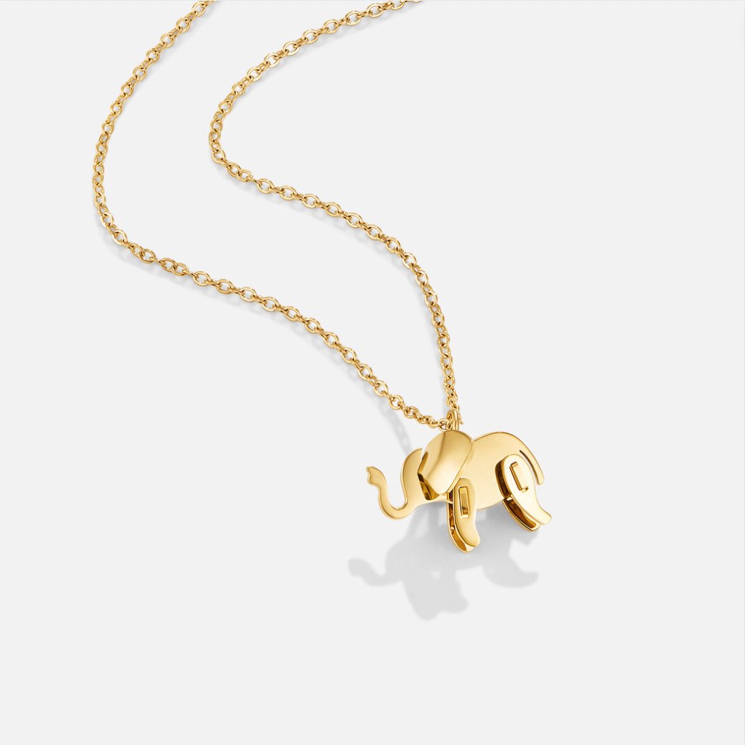 Gold Elephant Necklace, gold elephant pendant on a fine link chain, against white