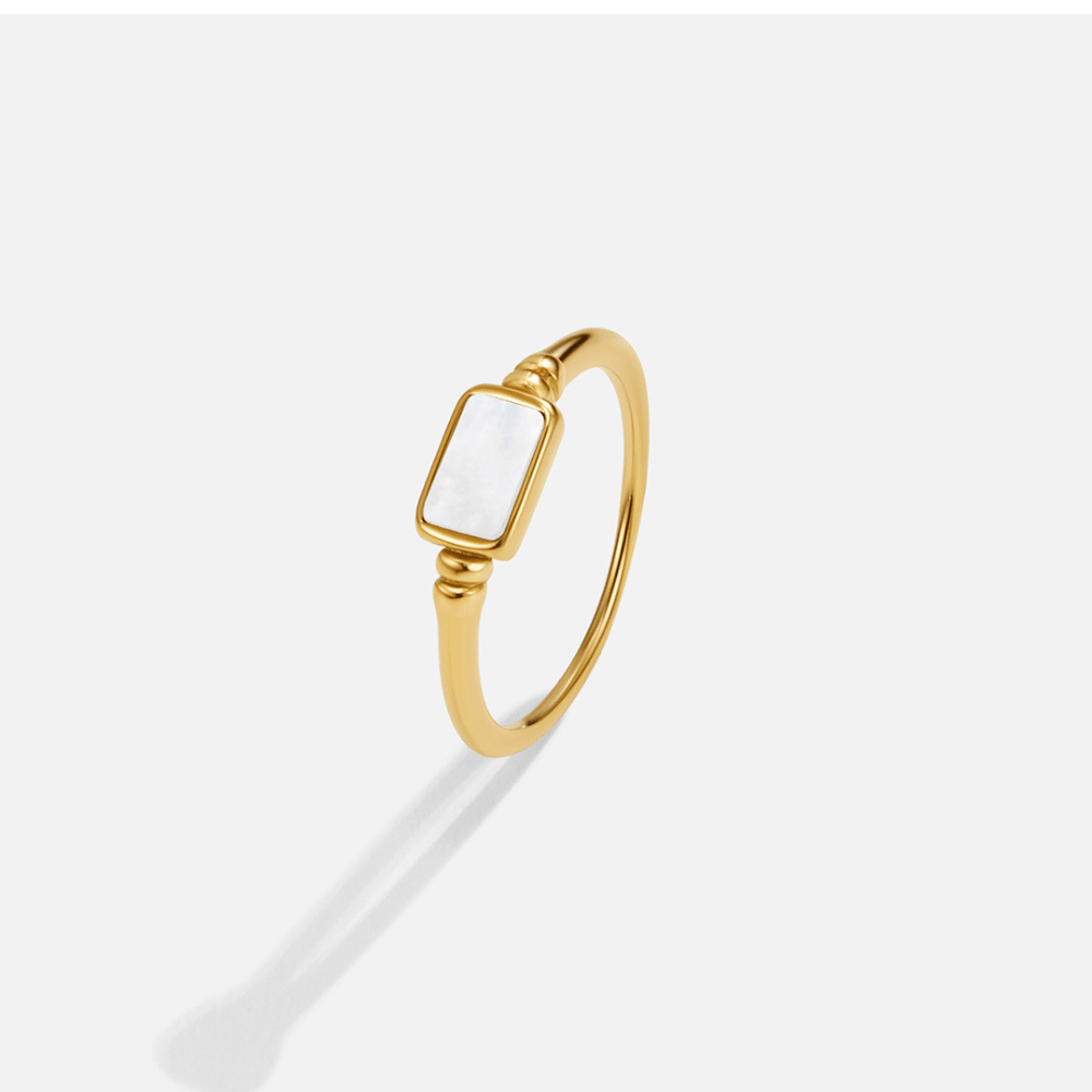 Gold Moonlight Pearl Shell Ring, gold ring with a rectangular white shell stone, on plain background