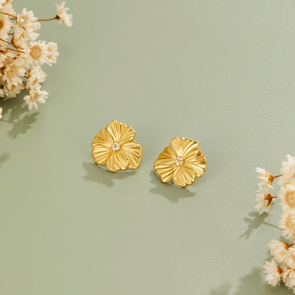 Golden Bloom Earrings, pair of gold flower stud earrings on sage green surface with dried flowers