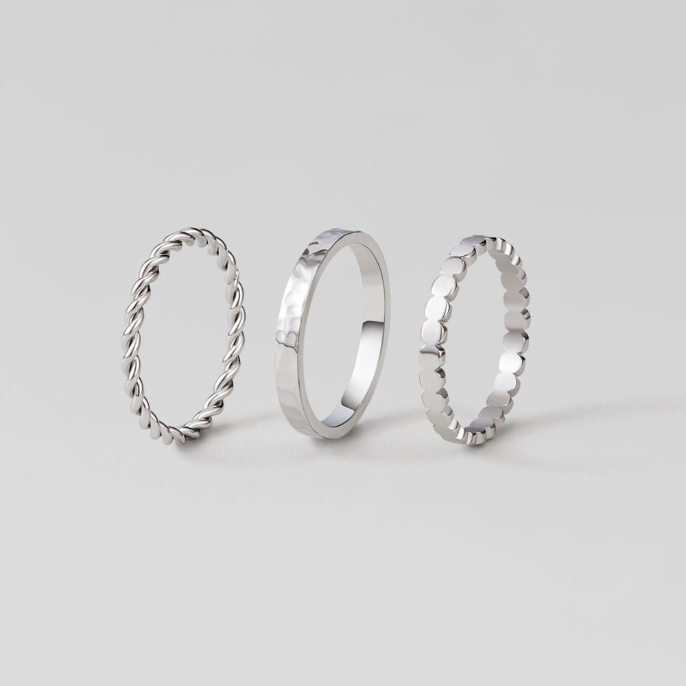 Hella Silver Stacked Ring Set, three silver stacking rings standing upright on grey background