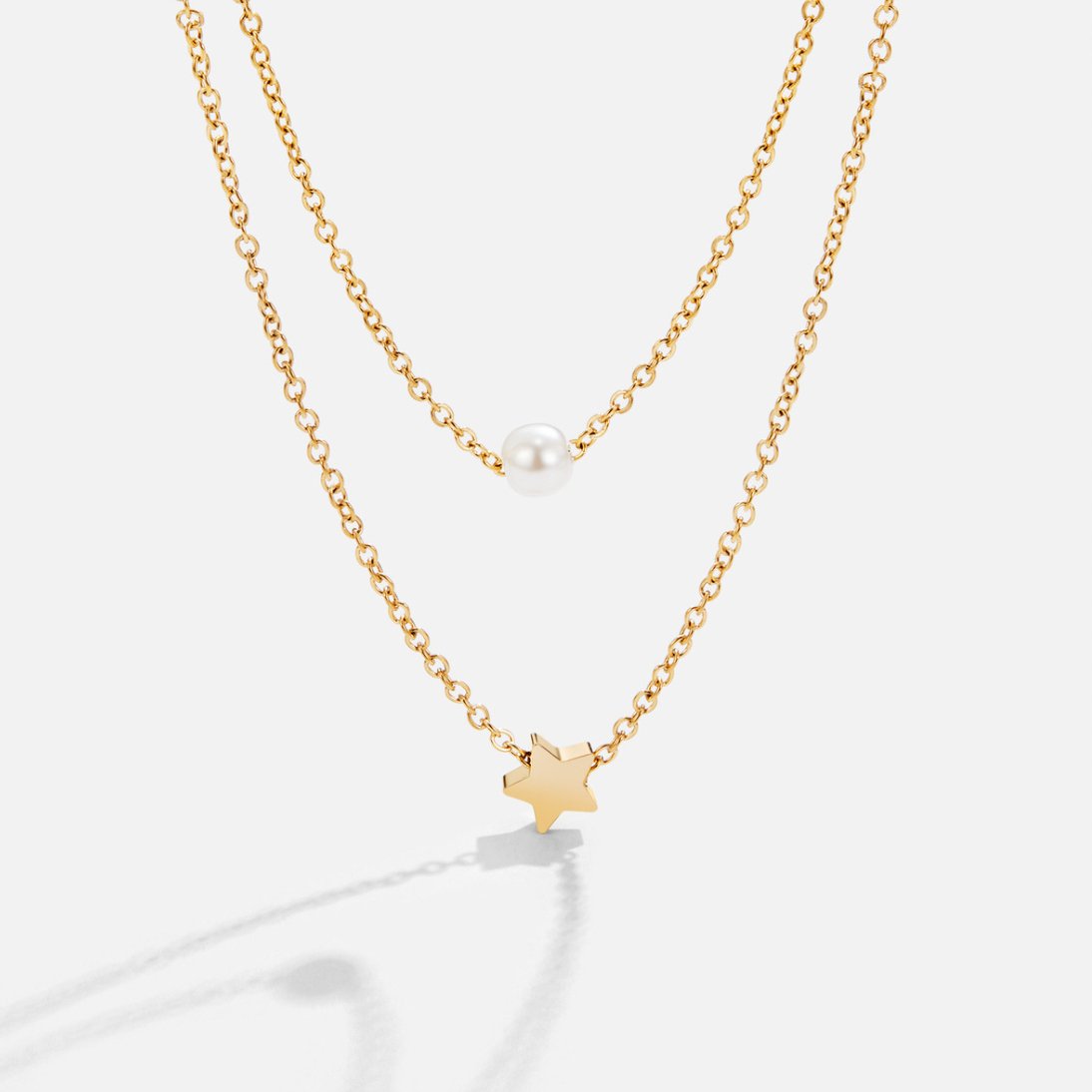 Layered Gold Star & Pearl Necklace, two gold chains layered, one with a pearl, one with a star