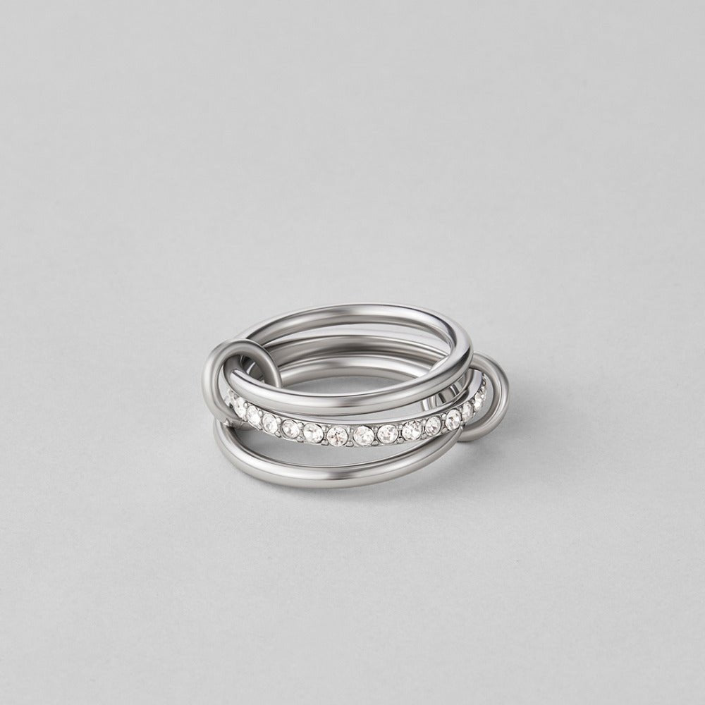 Layered Kaili Silver Ring, stacked silver rings on a grey surface, one row of small crystals