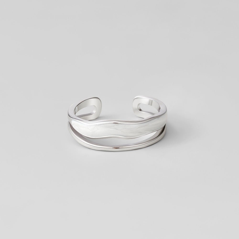 Layered Sahara Silver Ring, open silver band with wavy layered bands on grey backdrop