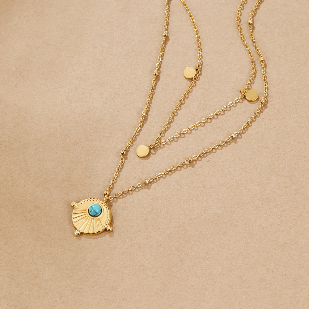 Layered Turquoise Necklace, flat lay of two gold chains with a turquoise-centred pendant