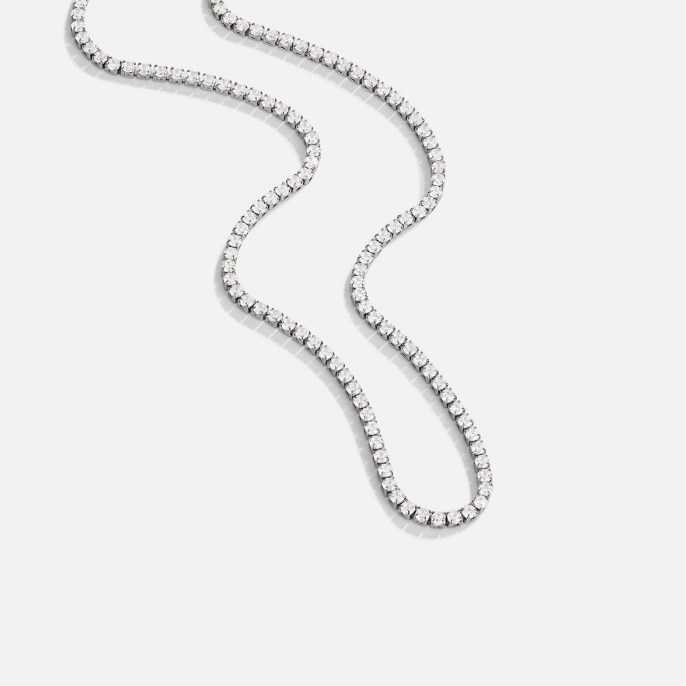 Cordelia Silver Crystal Necklace, flat-lay tennis chain of clear stones on light grey