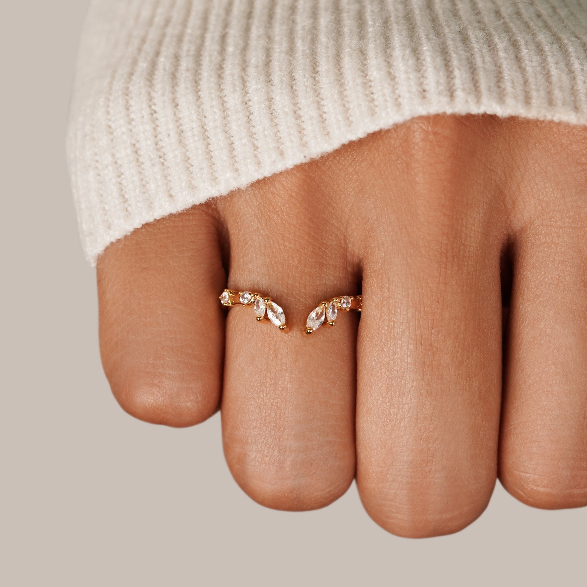 Lily Crystal Gold Vine Ring, worn on a hand in a cream knit sleeve, close-up on the finger
