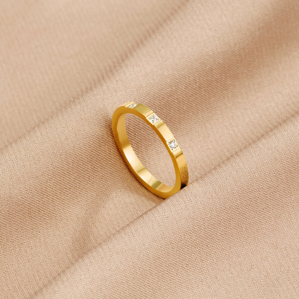 Lucia Crystal Ring, standing upright on a beige fabric with small square stones