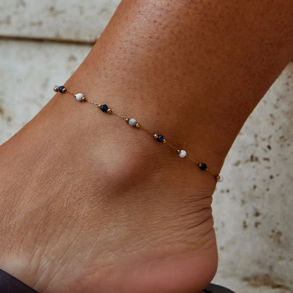 Lulu Natural Stone Anklet, worn on an ankle with blue and white beads and gold accents