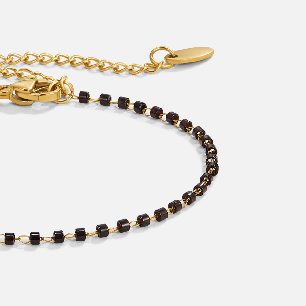 Maisie Black Bead Bracelet, close-up of dark beaded bracelet with gold clasp and extender chain