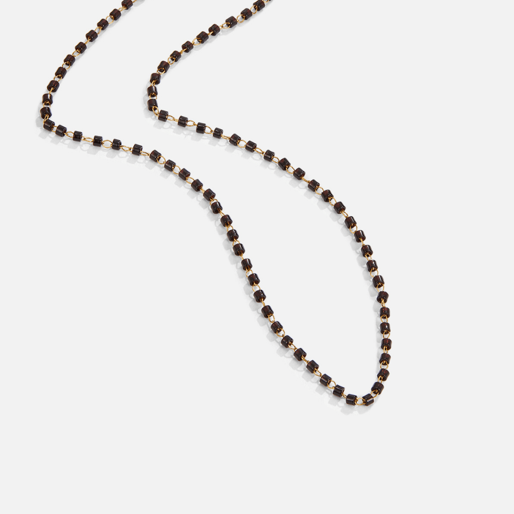 Maisie Black Bead Necklace, laid out on white, dark beads with gold links