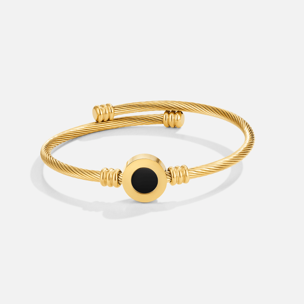 Melinda Gold Rotatable Bangle, gold twisted-cable bangle with round black centre disc, shown