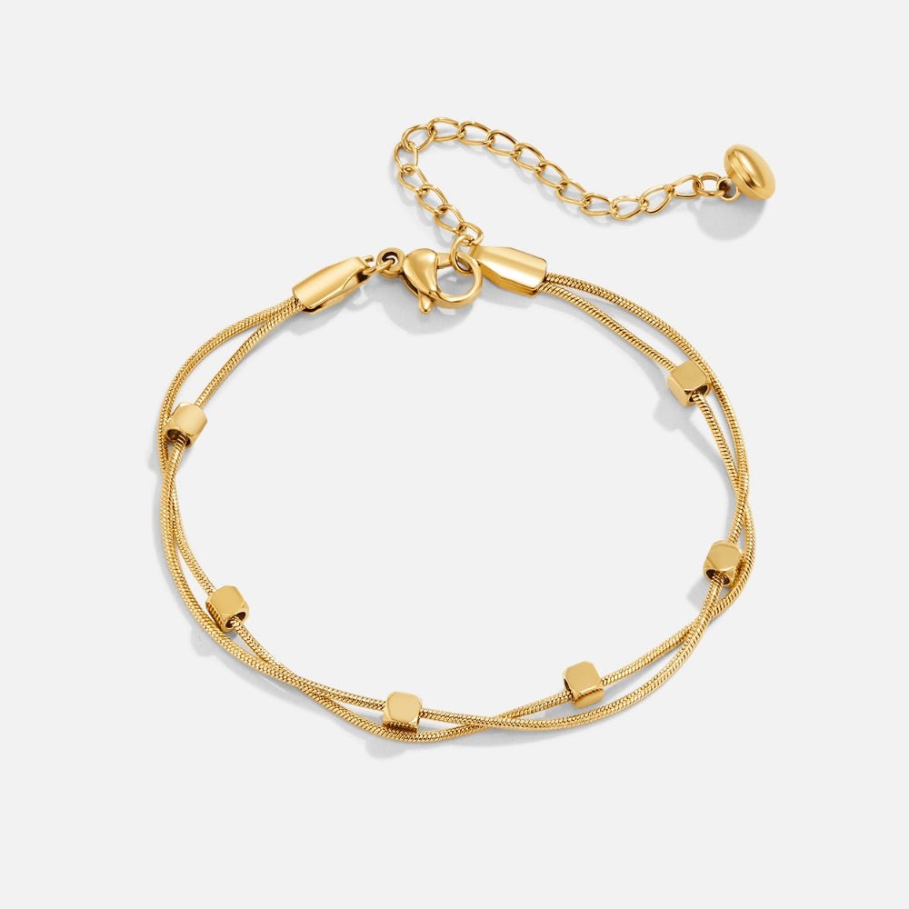 Mia Layered Cube Bracelet, flat lay of a gold bracelet with two chains and cube beads