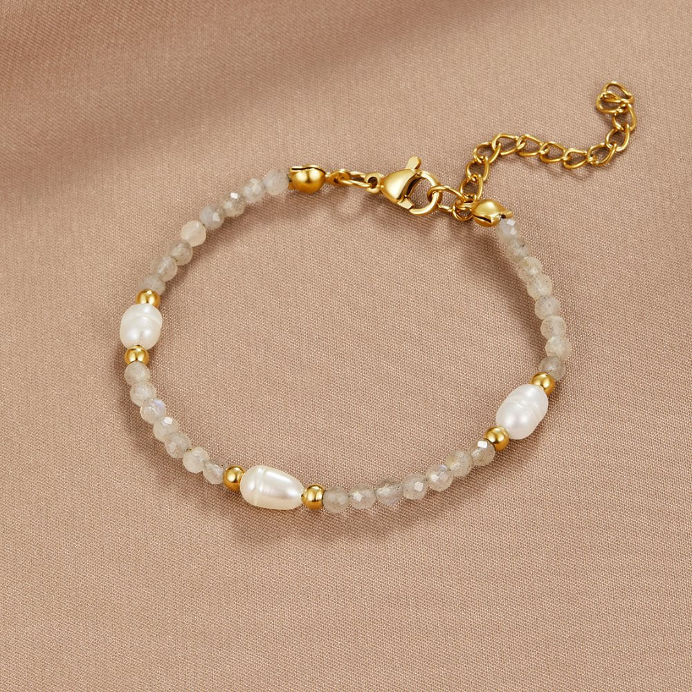 Moonstone & Pearl Bead Bracelet, laid flat on a beige fabric, grey beads with pearls and gold