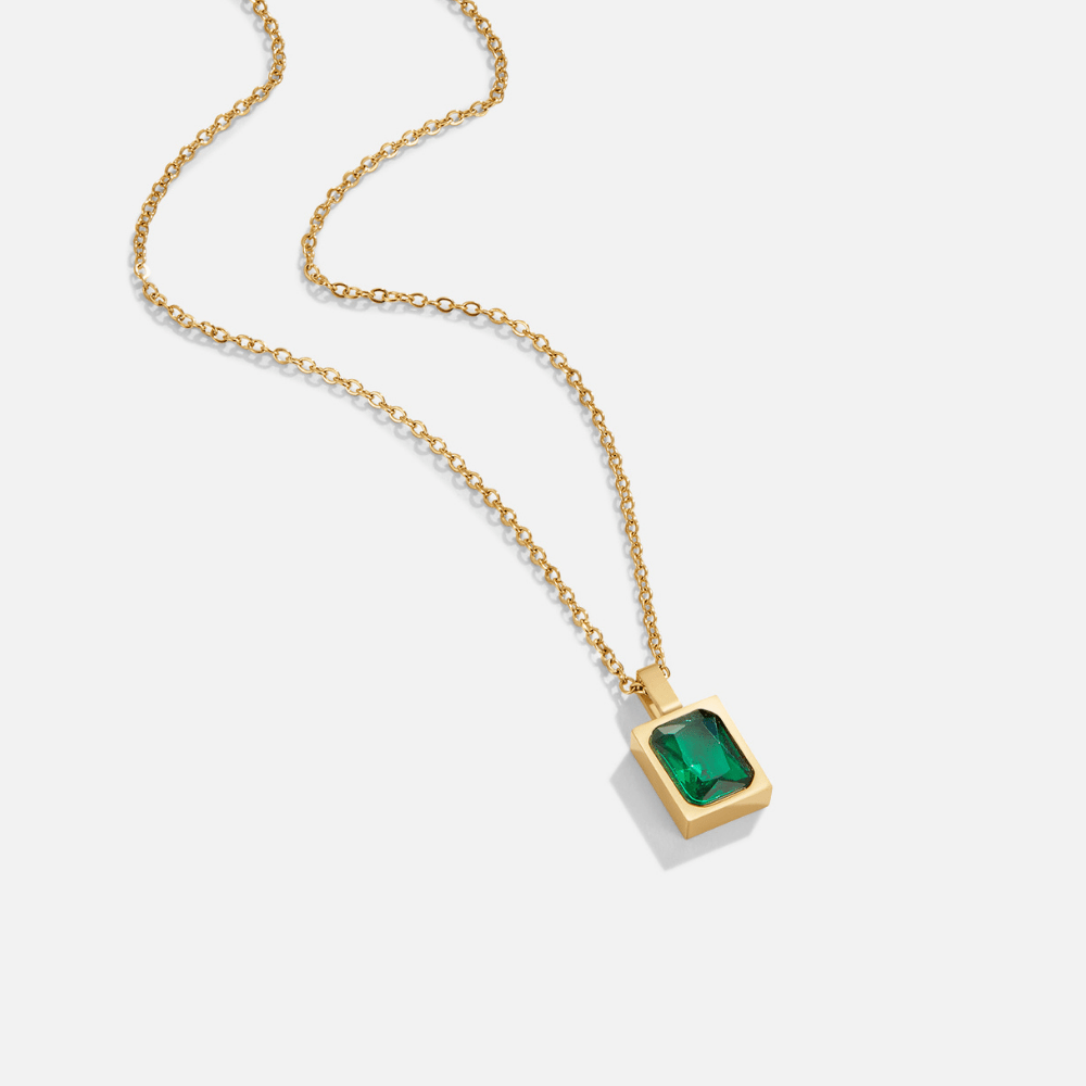 Mystic Green Crystal Necklace, gold chain necklace laid flat on white, emerald-cut green stone pendant