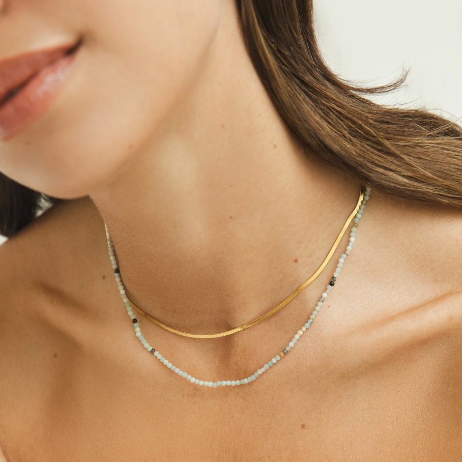Neesa Stone Beads Layered Necklace, worn on a neck layered with a gold chain and pale beaded strand