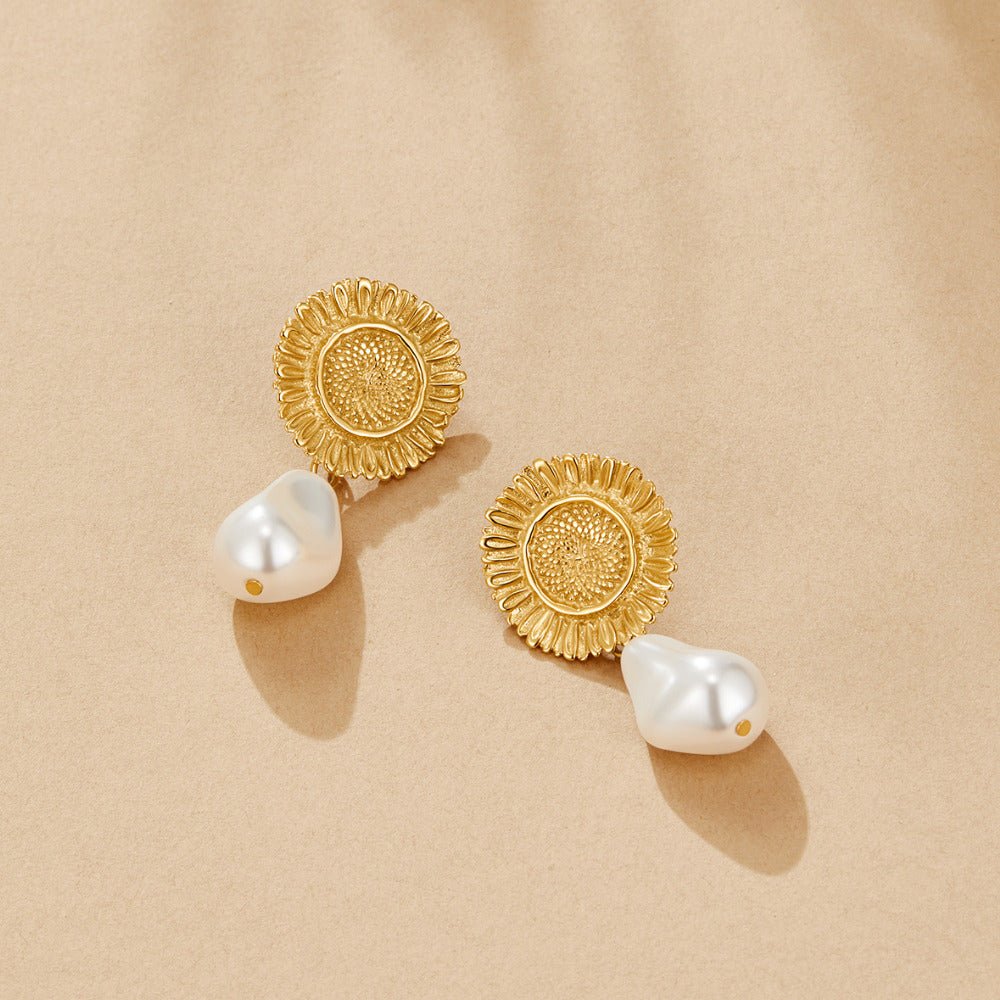 Pearl Blossom Drop Earrings, a pair laid flat on sand-coloured paper, gold sunflower studs