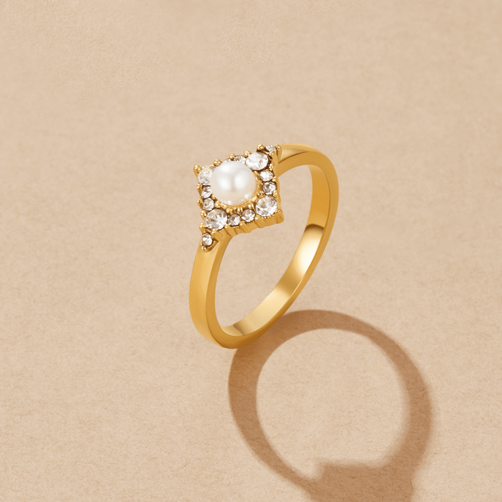 Pearl & Crystal Eternity Ring, standing on a beige surface, pearl centre with crystal halo