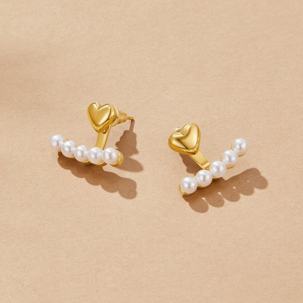 Pearl & Heart Romance Earrings, pair of gold heart studs with curved rows of pearls on beige