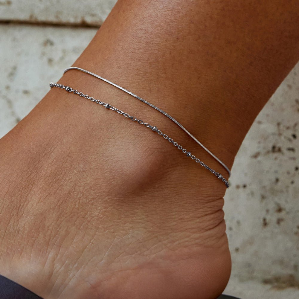 Pia Silver Layered Anklet, worn on an ankle with two fine silver chains layered